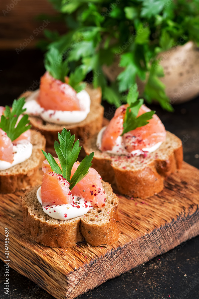 Rye bread, salmon and soft cheese. Sandwich with red fish. Selective focus. Rye bread, salmon and soft cheese. Sandwich with red fish. Selective focus.