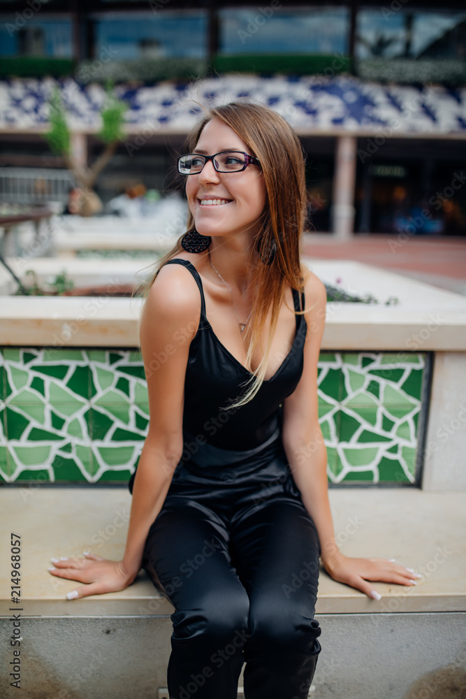 Young beautiful woman sitting on the street bench Young beautiful woman sitting on the street bench