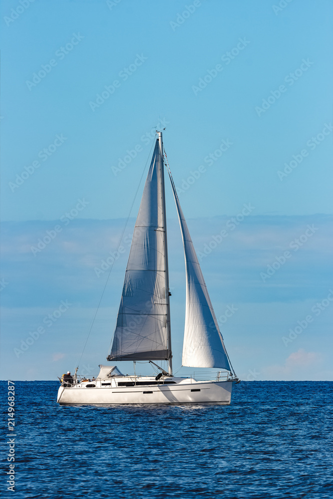 White sailboat traveling at Riga