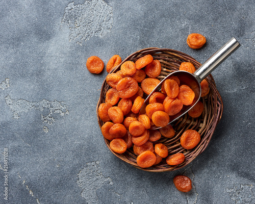 Dried apricots on gray background. witn copy space. Top view. photo