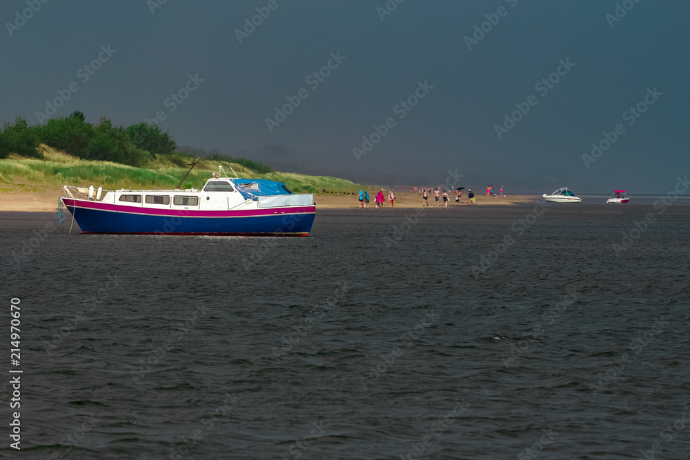 Obraz premium Small blue passenger ship