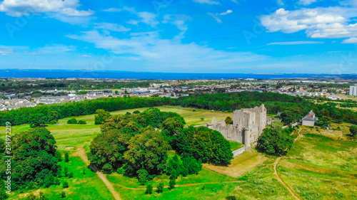 Aerial view over Craigmillar Castle and the city of Edinburgh © 4kclips