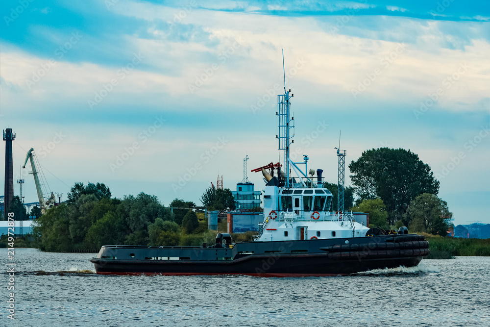 Black tug ship underway
