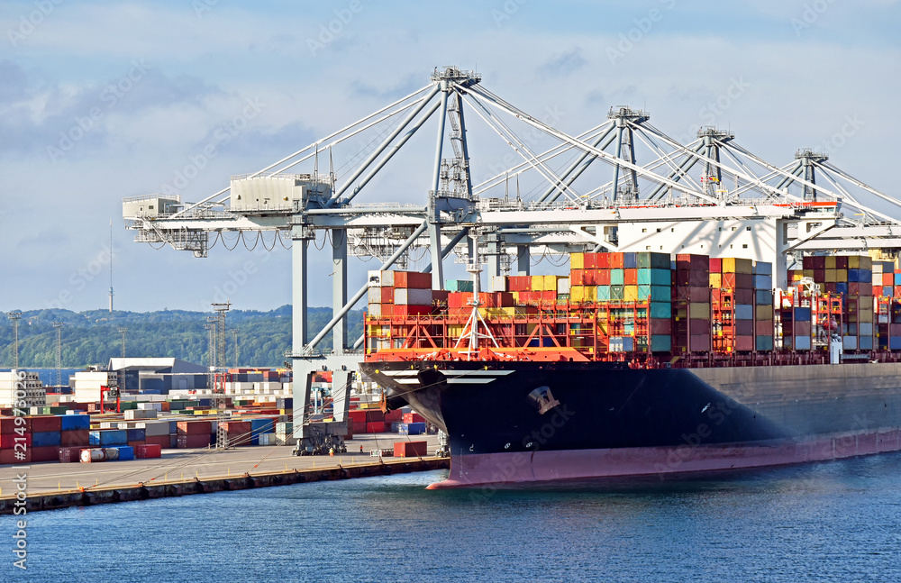 Large container ship has docked in the port o and is loading and unloading