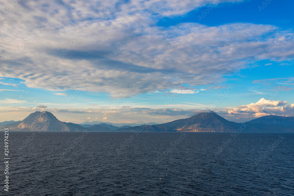 View of the Greek island of Makri from the ferry at sunset. Greek islands in the Ionian Sea View of the Greek island of Makri from the ferry at sunset. Greek islands in the Ionian Sea
