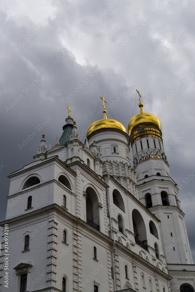 Inside the Moscow Kremlin. The bell tower of Ivan the Great against the background of thunderclouds. Inside the Moscow Kremlin. The bell tower of Ivan the Great against the background of thunderclouds.