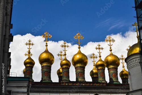 Golden Orthodox crosses and domes of the Church of the Nativity (Verkhospasskiy Sobor) at Kremlin, Moscow with blue sky