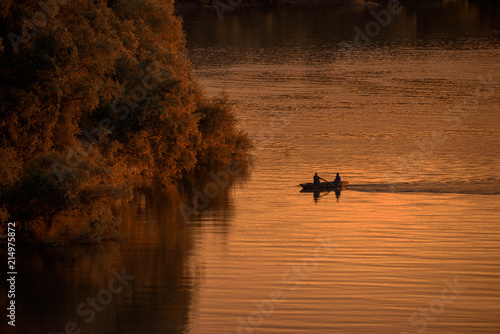 Boat sailing at sunset