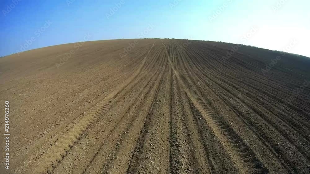 View of the field from the tractor cab in motion. Video shooting from the cab of the machine running in the field. View of the field from the tractor cab in motion. Video shooting from the cab of the machine running in the field.