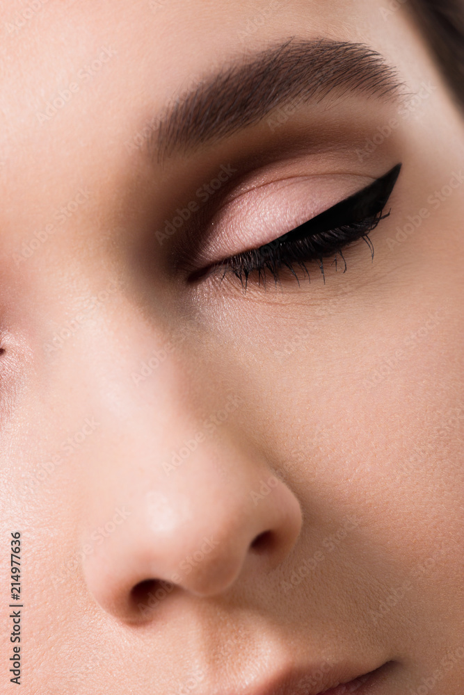 closeup female eyes with long eyelashes and black eyeliners