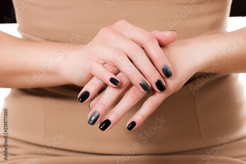 Manicured Nail with Black Matte Nail Polish. Fashion Manicure. Long Nails with Dark Nailpolish isolated. Salon. Nail Art. Black Ring