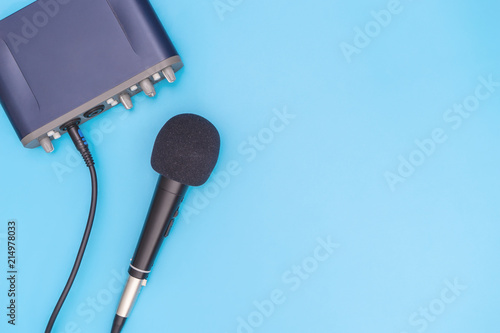 Black microphone on blue background for music concept