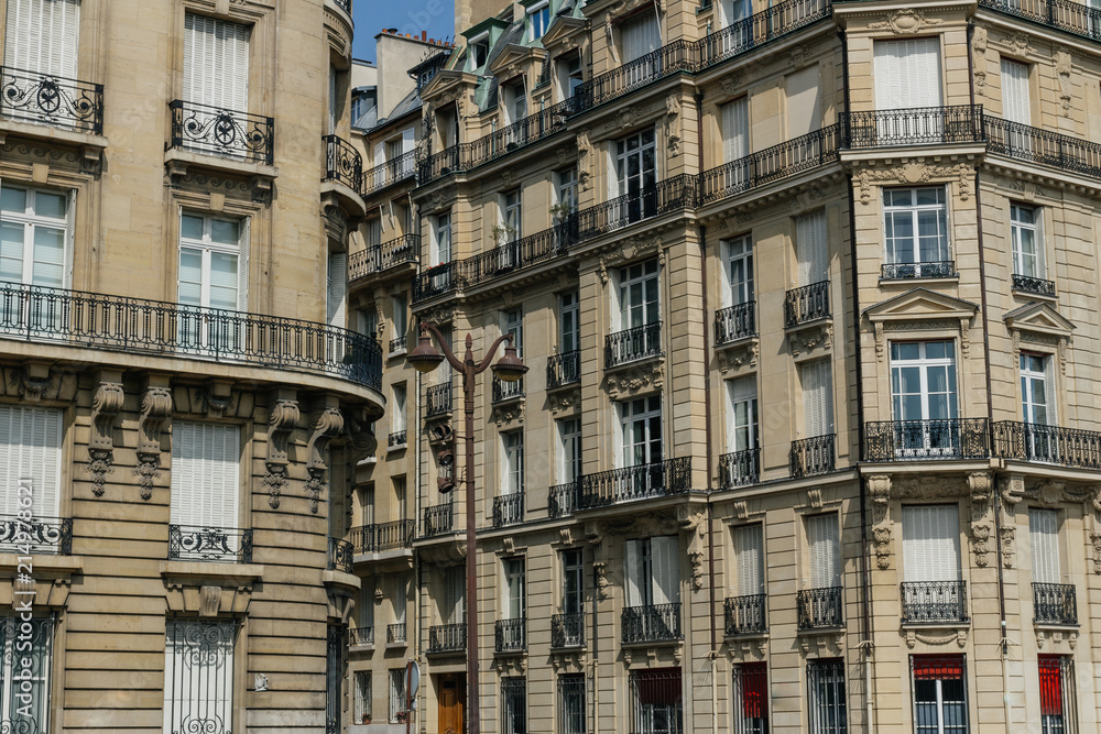 Paris residential buildings. Old Paris architecture, beautiful facades, typical french houses. Famous travel destinations in Europe. Backgrounds. City life, lifestyle and expensive real estate concept