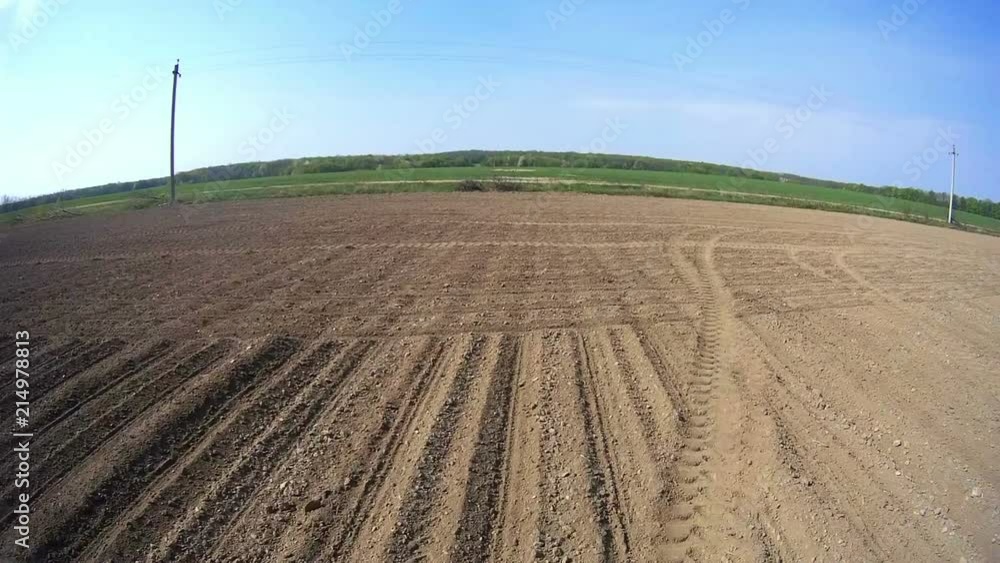 View of the field from the tractor cab in motion. Video shooting from the cab of the machine running in the field. View of the field from the tractor cab in motion. Video shooting from the cab of the machine running in the field.