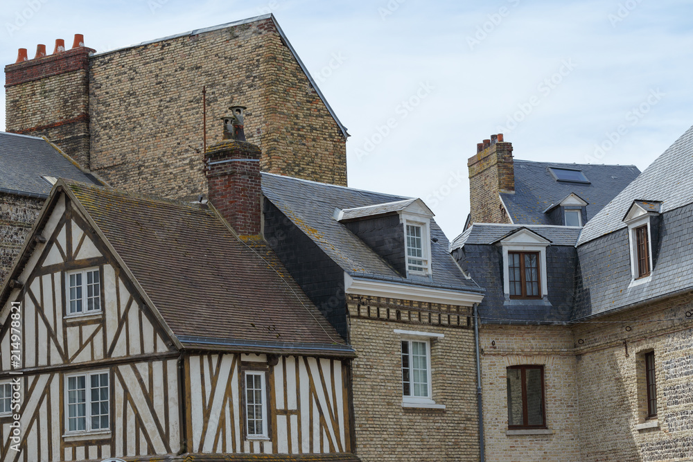 Facades of traditional residential houses in the region of Normandy, France. Norman style half-timbered houses. Beautiful european cityscape with atmospheric streets, typical french architecture Facades of traditional residential houses in the region of Normandy, France. Norman style half-timbered houses. Beautiful european cityscape with atmospheric streets, typical french architecture