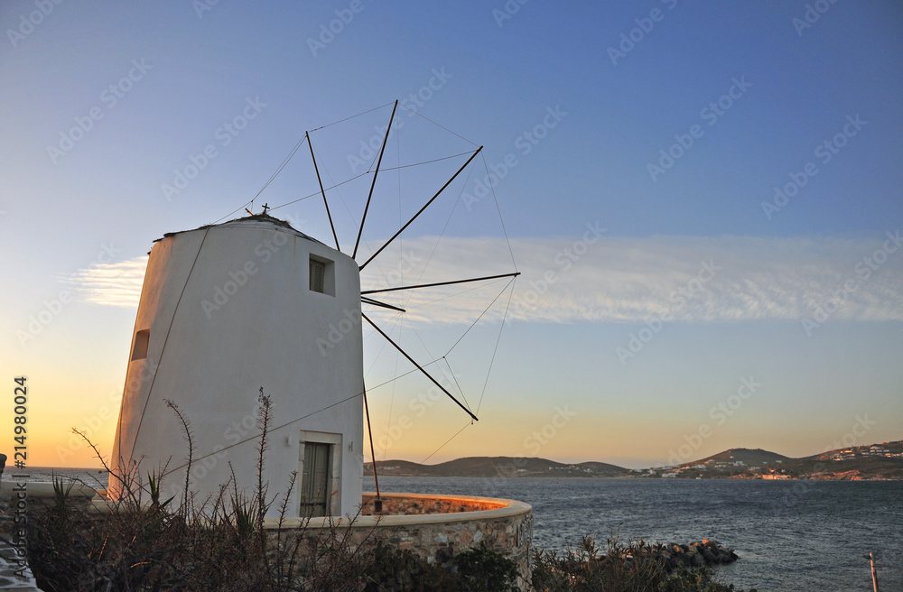 Traditional mediterranean greek windmill on sunset