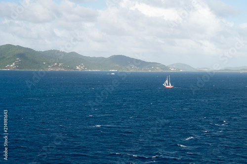 Tiny sailboat in the vast Caribbean sea photo