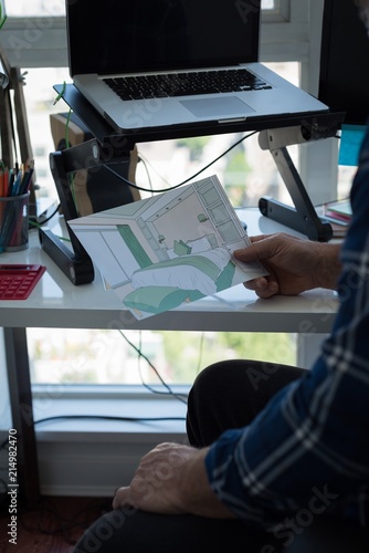 Man looking at architectural chart photo