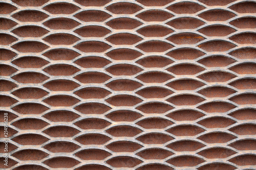 Metal solid grating with holes creating a rhythmic pattern