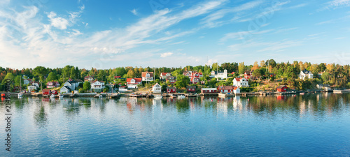 Small islands in the morning near to Stockholm. Swedish landscape with traditional red houses photo