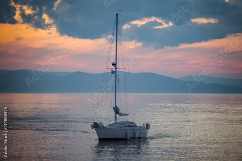 Sailing boat with a beautiful sunset in the background photo