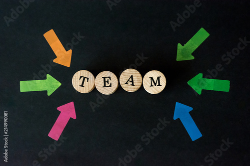 Word team written with wooden blocks on black background