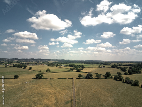 Aerial view on cheshire plains and fields. Summer sky with white clouds
