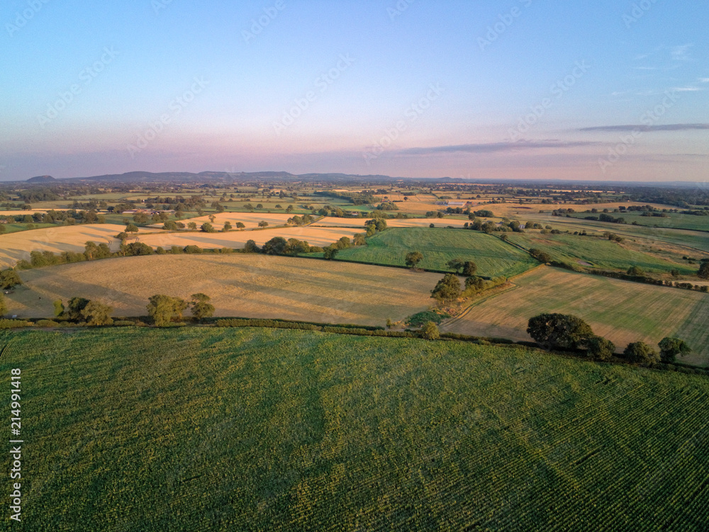 Aerial view on cheshire plains and fields. Summer sunset behind