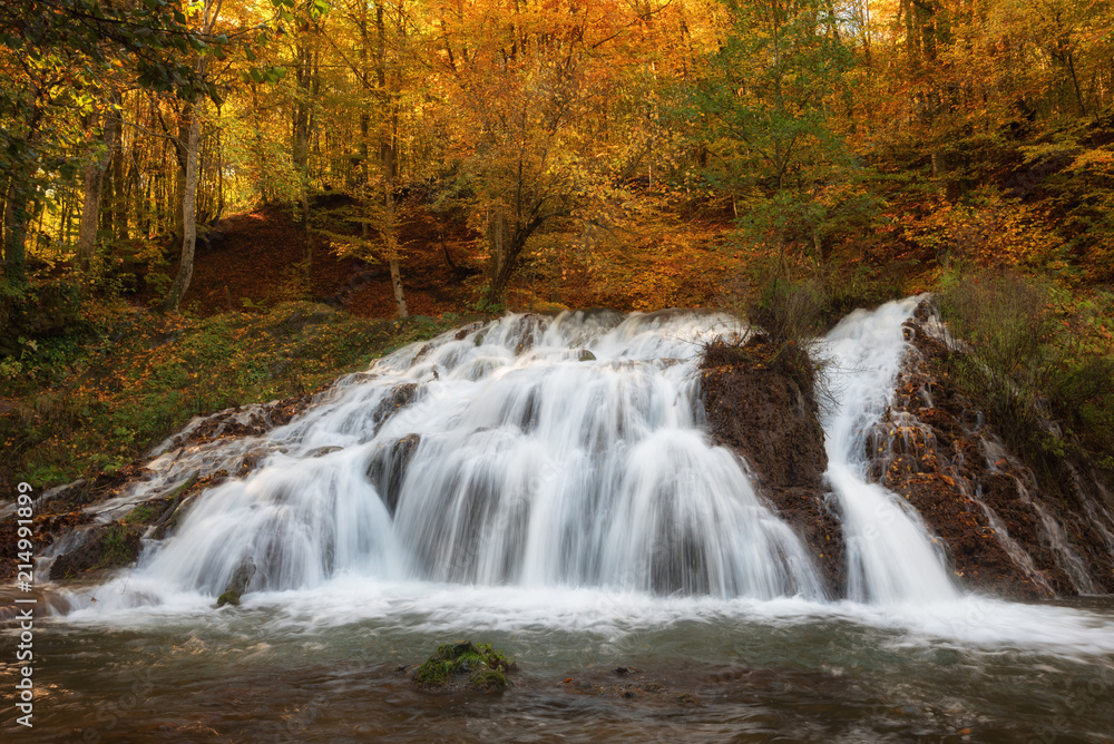 Dokuzak waterfall in Strandja mountain, Bulgaria during autumn. Beautiful view of a river with an waterfall in the forest. Magnificent autumn landscape. Dokuzak waterfall in Strandja mountain, Bulgaria during autumn. Beautiful view of a river with an waterfall in the forest. Magnificent autumn landscape.