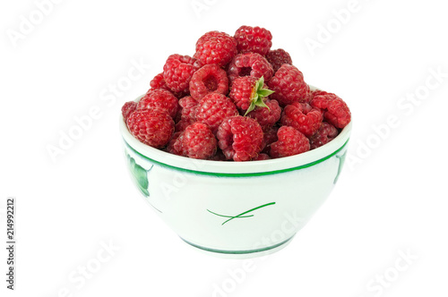 Big hile of fresh raspberries in the  bowl isolated on the white background photo