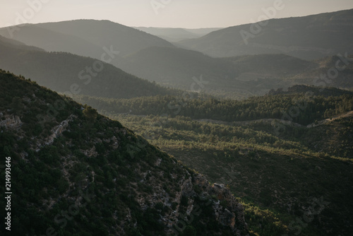 A lot of huge beautiful hills covered with forest and with the hill on the front in the evening in Spain © Roman Tyukin