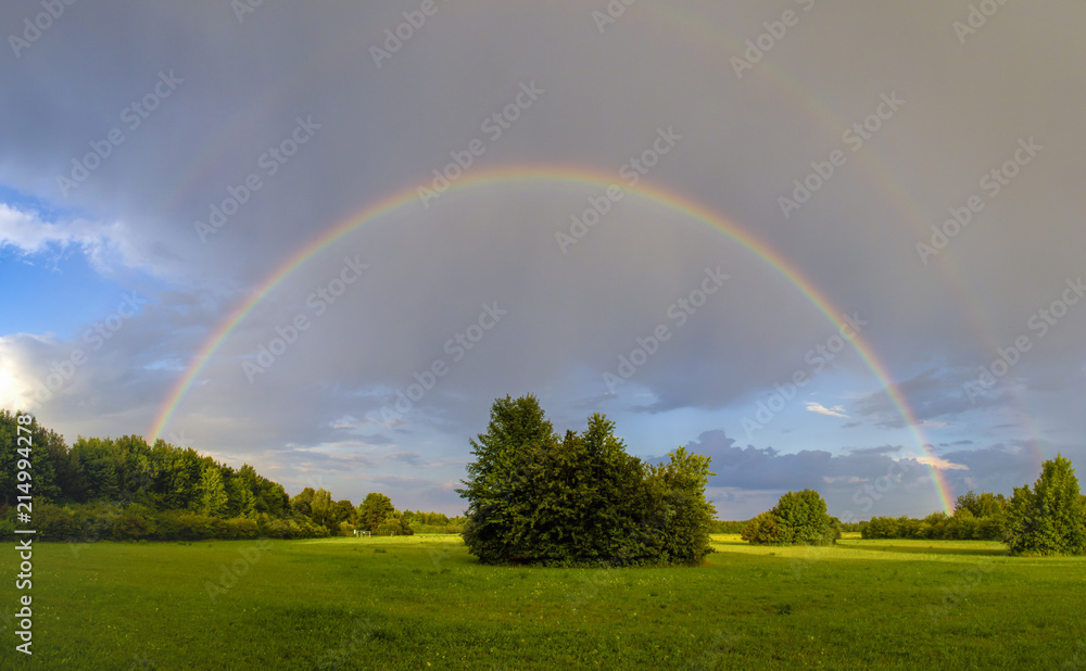 Rainbow after a thunderstorm over a road Rainbow after a thunderstorm over a road