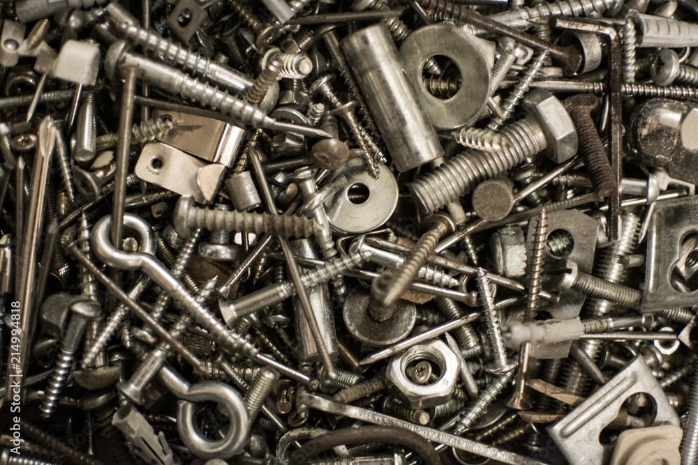 Pile of screws nuts washers and bolts out of metal in a box from a workshop with standard parts. Pile of screws nuts washers and bolts out of metal in a box from a workshop with standard parts.