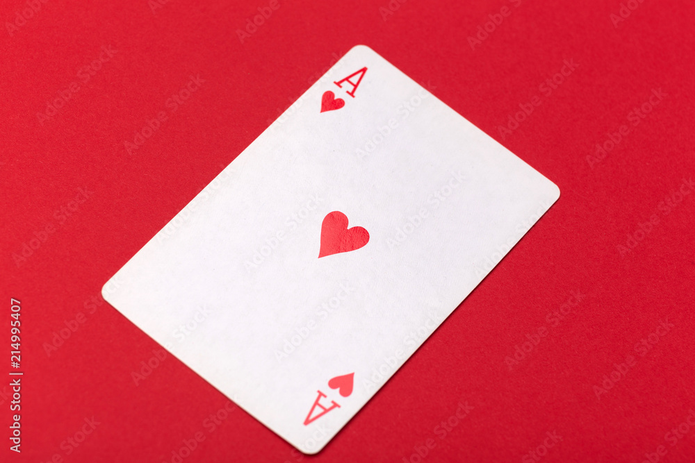 playing card ACE of hearts on red background