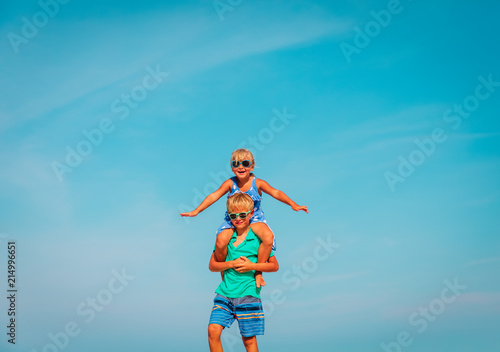 happy little boy and girl play at sky