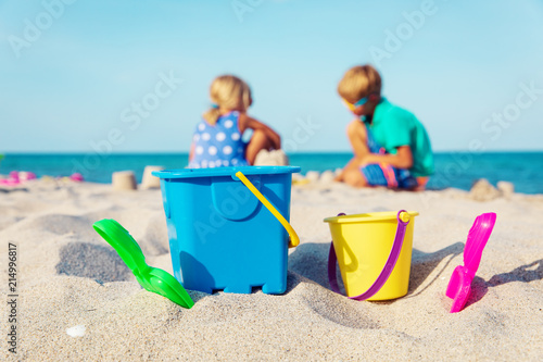 toys and kids-boy and girl- playing on the beach