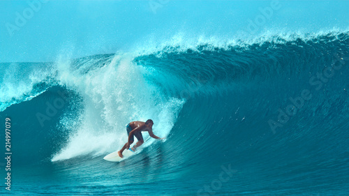 CLOSE UP: Extreme sportsman having fun riding a beautiful barrel ocean wave.