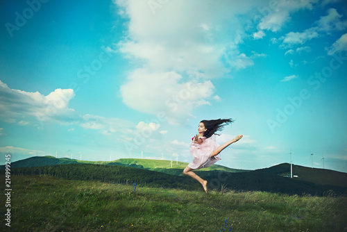 Girl in a field jumping in the air, Shipka, Stara Zagora, Bulgaria photo