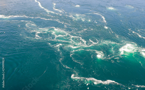 Abstract water currents, rapids and whirlpools in fjord. Saltstraumen, Norway