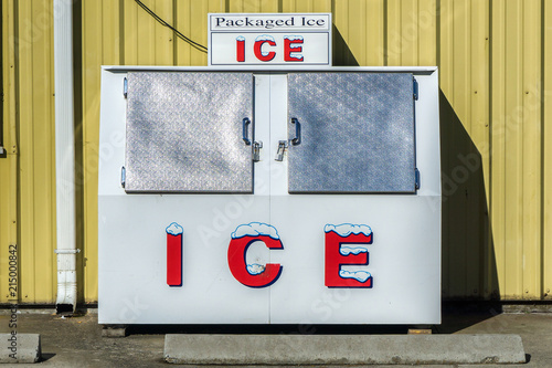 Fényképezés Packaged Ice freezer machine against a yellow wall during a hot and sunny day of summer outside a grocery store, Oregon, USA