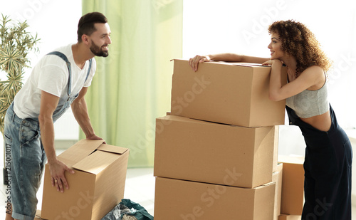 young couple unpacking boxes in a new house © ASDF