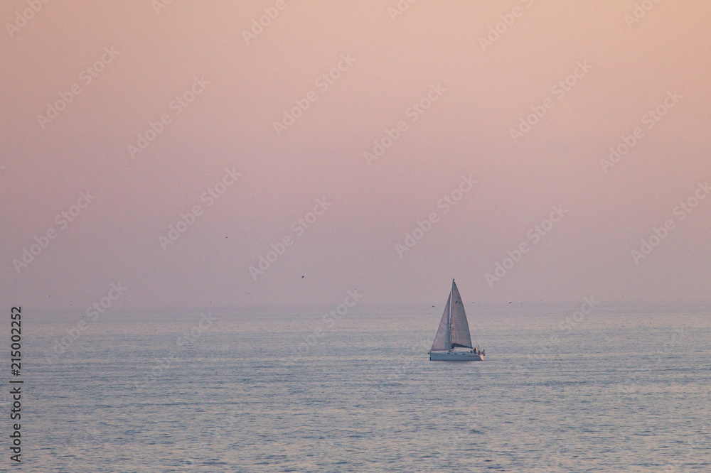 Distant Sailboat at Sunset