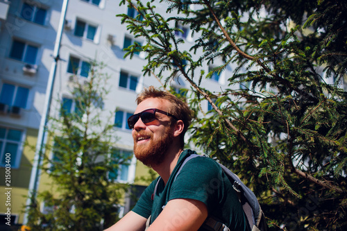 adult man in playground. man with beard and glasses. stylish modern young