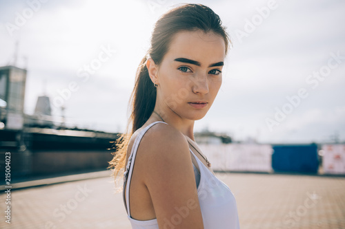 Portrait of beautiful young woman in the open urban space