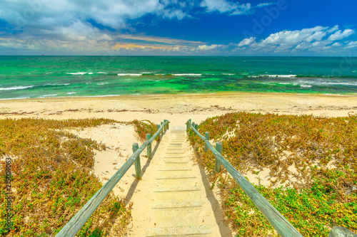 Wooden stairs for Mettams Pool, North Beach near Perth, Western Australia. Mettam's is a natural rock pool protected by a surrounding reef. Summer season. photo