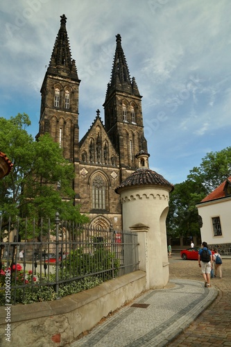 Prague, Czech republic / Europe - June 9 2017: Significant historical basilica of Saint Peter and Pavel from 11th century made of stone standing at Vysehrad, two tall towers, sunny day, street