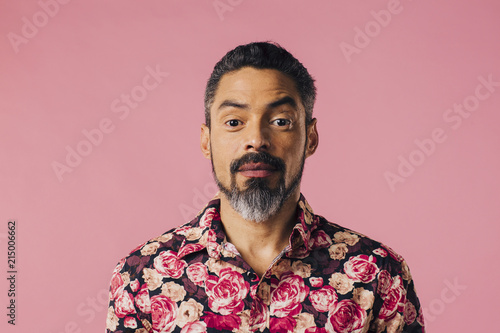 Valokuva Portrait of a friendly, mature man with silver beard and flowery shirt, isolated