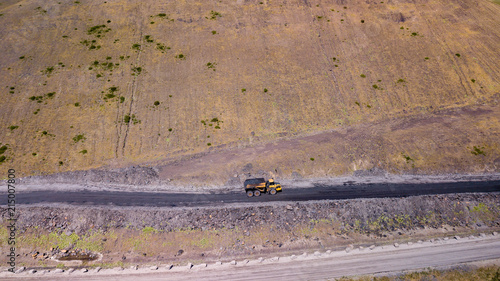 Aerial drone view of trucks carrying freshly excavated coal from an opencast mine photo