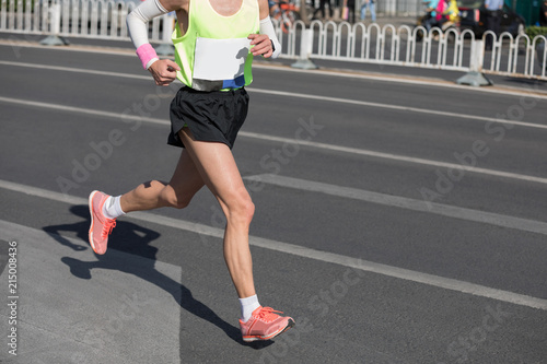marathon runners legs running on city road