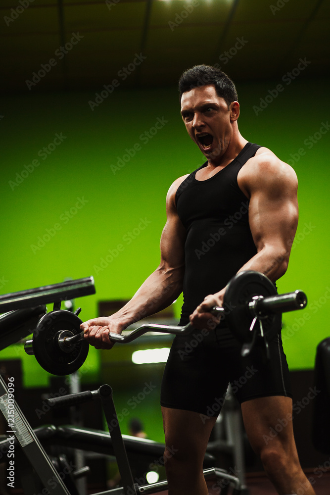 The man in the gym.Guy's training.The Sports Guy.Man's health The man in the gym.Guy's training.The Sports Guy.Man's health